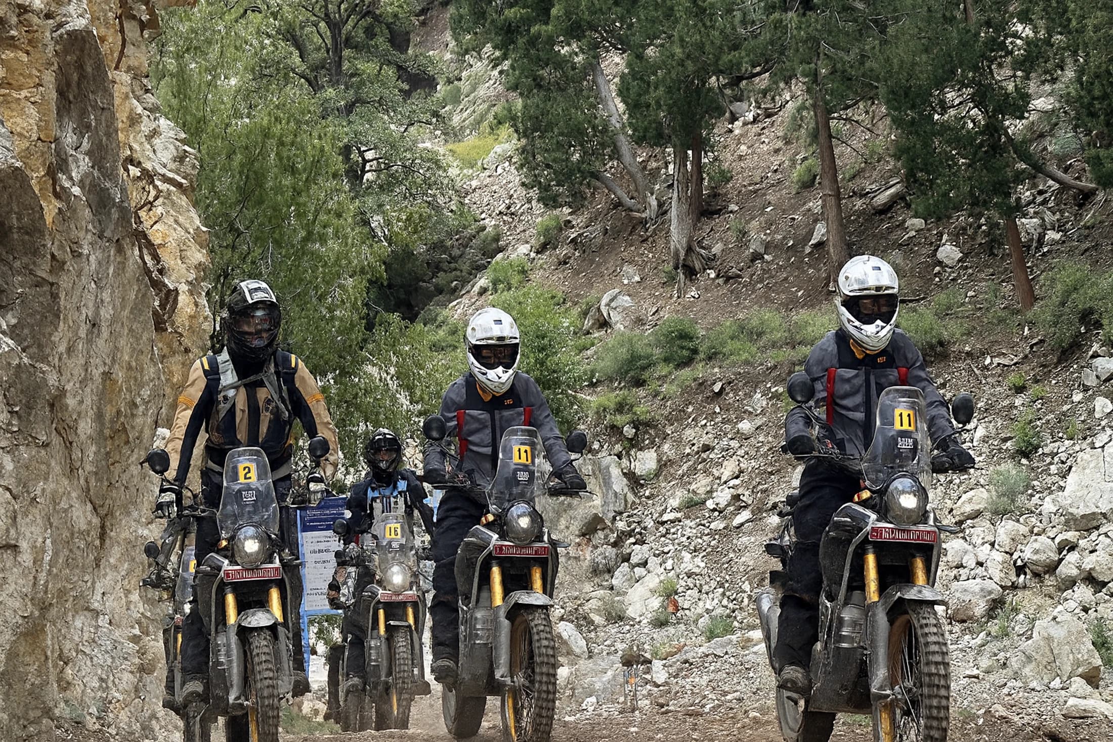 A group of riders making their way along a dirt trail