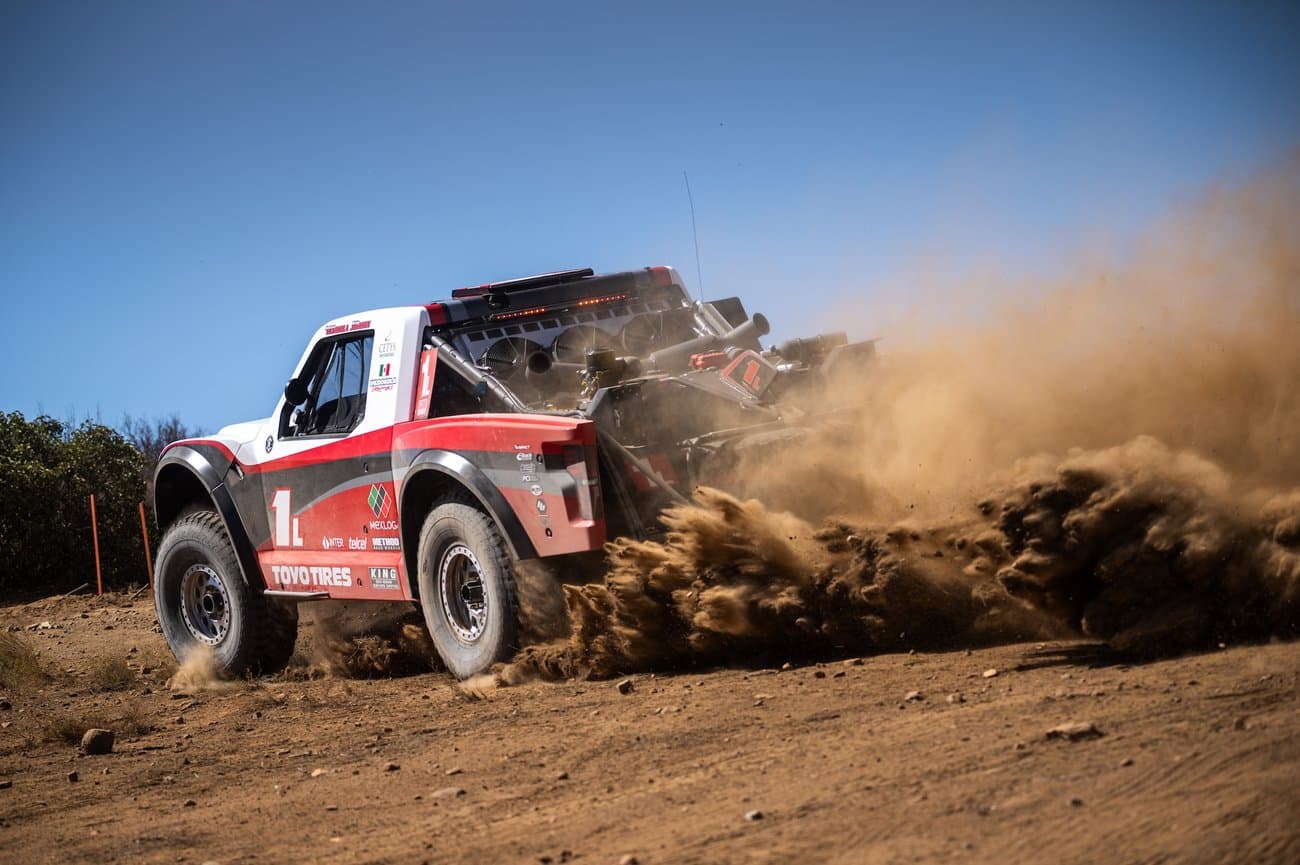 Rick Johnson's Baja trophy truck kicking up dust in the desert